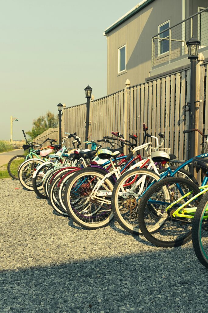 A row of colorful bicycles parked on gravel